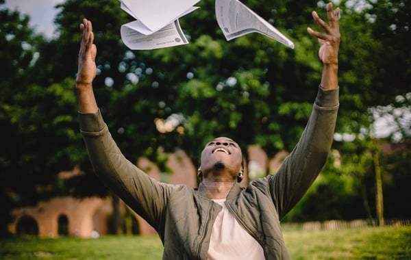 Overjoyed employee throwing papers in the air