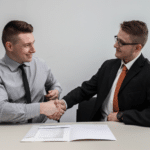 two man shaking hands while smiling